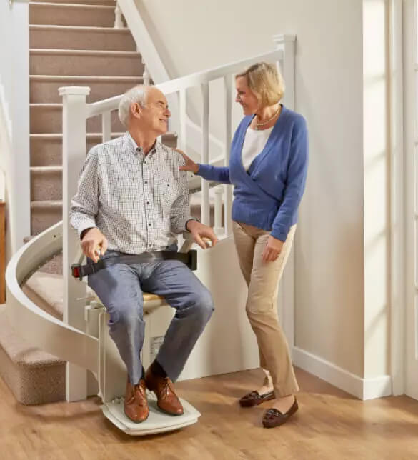 Couple enjoying the acorn curved stairlift scotland
